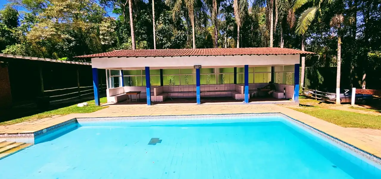 Área de convivência coberta ao lado da piscina.
